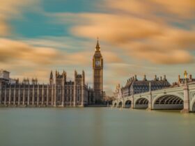 brown tower clock under cloudy sy