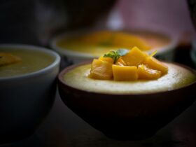 sliced orange fruit on blue ceramic bowl