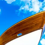 Low-angle Photography of White and Brown Boat Under Cloudy Sky