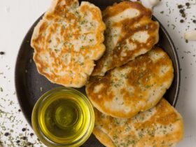 a plate of food with some bread and a bottle of olive oil