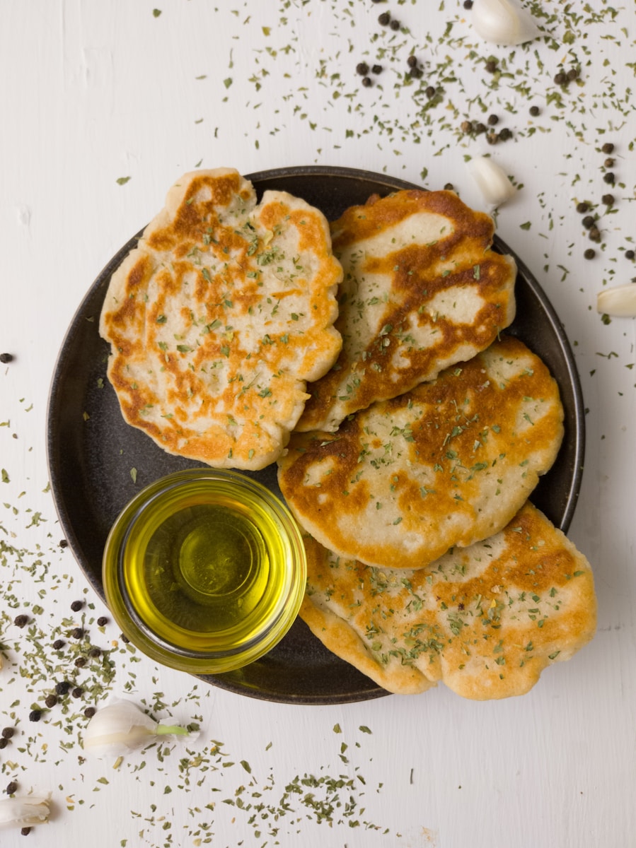 a plate of food with some bread and a bottle of olive oil