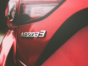 closeup photography of red Mazda 3 vehicle