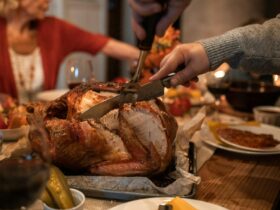 Person Slicing Meat on Table